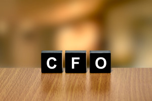 CFO or chief financial officer on black block with blurred background